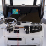 Blackout helm dash available with optional dual screens, stainless steel wheel with power knob, and electronic trim tabs